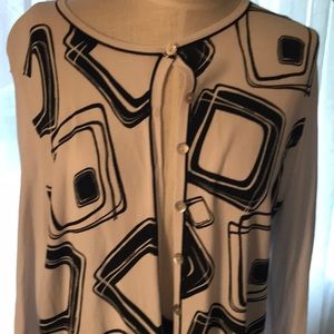 Black skirt and white sweater with black design